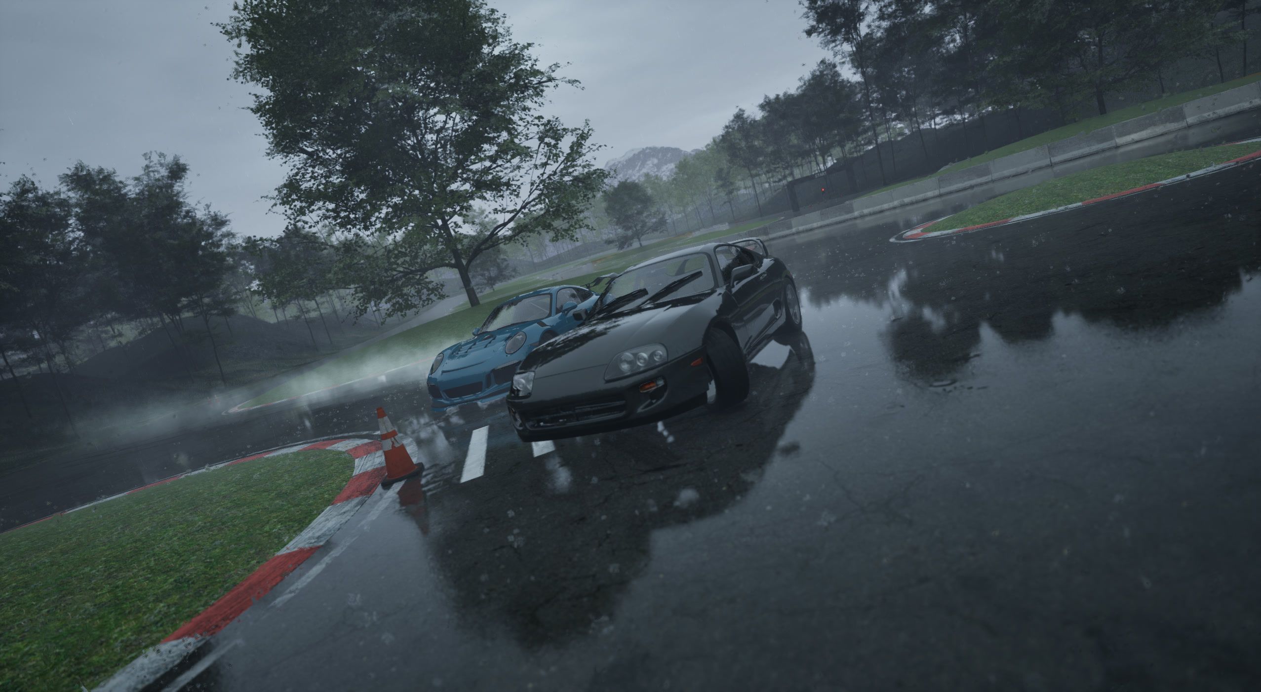 Tandem pair in rain spray past a red and white kerb