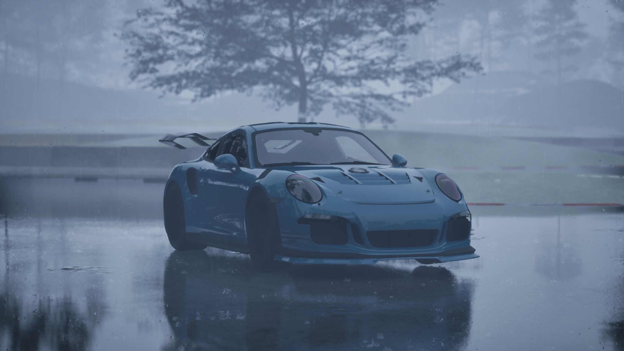 Teal car on a flooded track, reflected in standing water